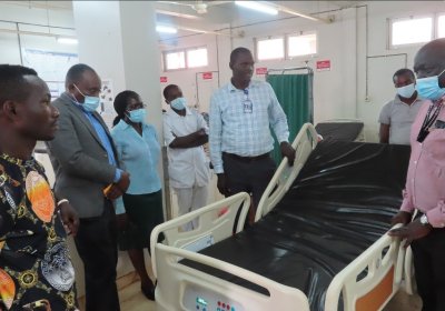 Dr. Freddie Mukasa Kibengo (on the right) handing over the Emergency Unit bed to the hospital administrators